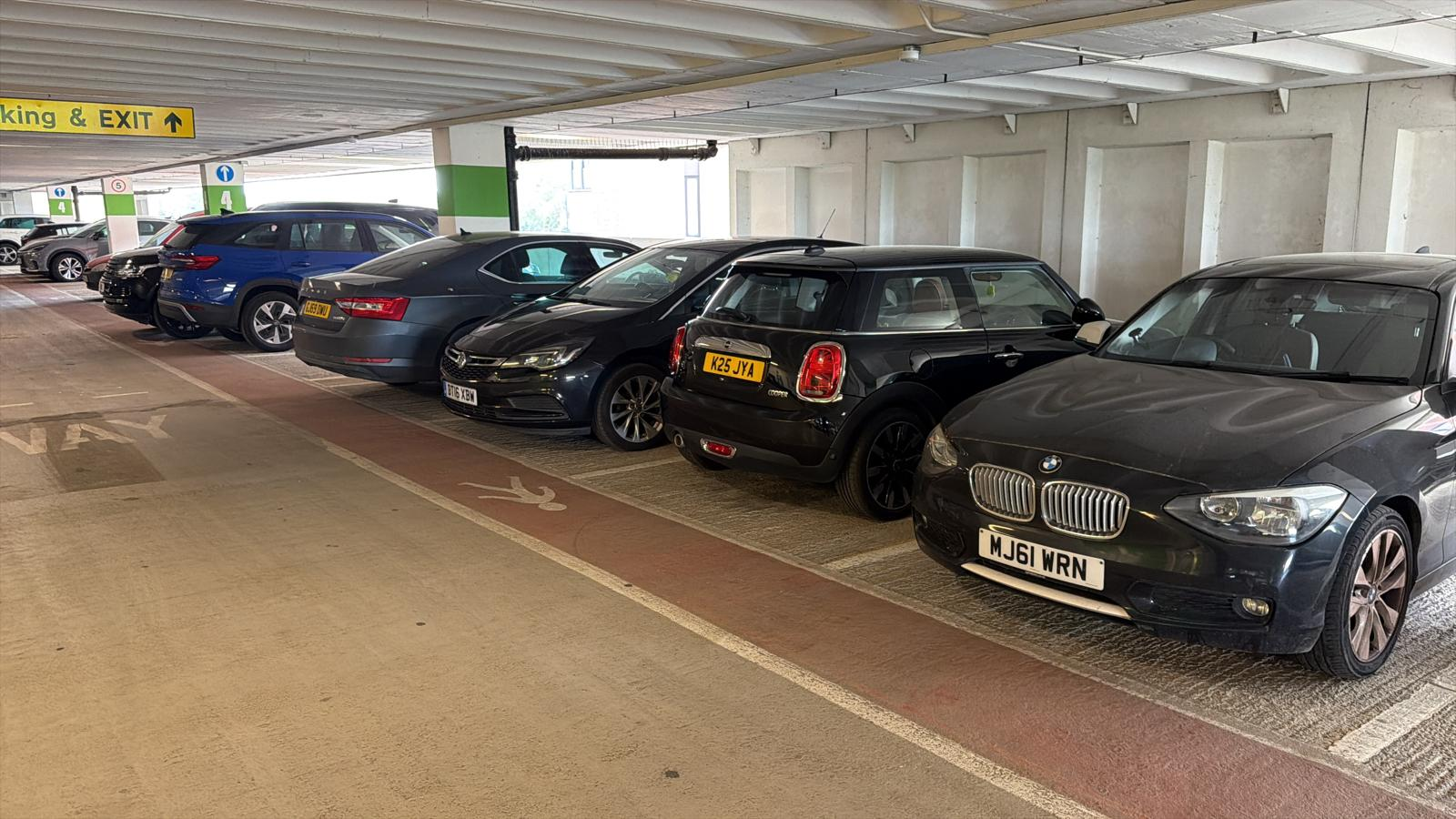 Customer vehicles parked under cover inside facility